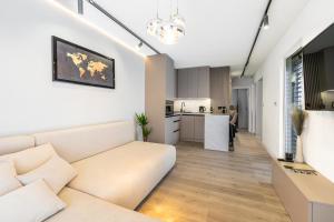 a living room with a couch and a kitchen at Challet Závažná Poruba in Závažná Poruba