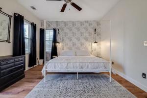 a bedroom with a bed and a ceiling fan at Honey, I’m Home near Savannah - Seen on HGTV in Savannah