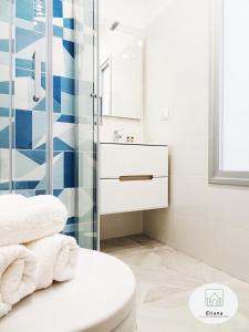 a bathroom with a toilet and a glass shower at Eliana Deluxe & Modern Apartment in Turin