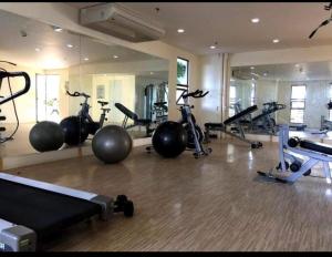 a gym with several exercise bikes and a mirror at Condo units in Mabolo Garden Flats Cebu in Cebu City