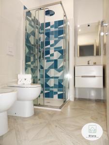a bathroom with a toilet and a glass shower at Eliana Deluxe & Modern Apartment in Turin