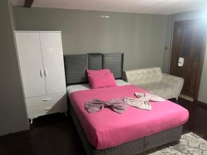 a bedroom with a pink bed with bows on it at Konak Kardelen in Yıldırım