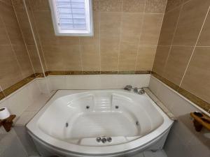 a white bath tub in a bathroom with a window at Konak Kardelen in Yıldırım