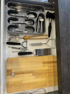 a drawer filled with cooking utensils in a cabinet at Bogyó Family Land Budapest in Budapest