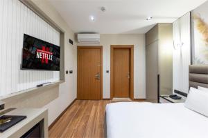a hotel room with a bed and a tv at Dem Premium Hotel - Round Trip Airport Service - Istanbul International Airport in Arnavutköy