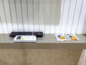 a keyboard and a remote control sitting on a table at Dem Premium Hotel - Round Trip Airport Service - Istanbul International Airport in Arnavutköy