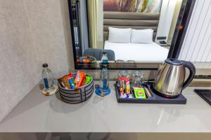 a bathroom counter with a sink and a mirror at Dem Premium Hotel - Round Trip Airport Service - Istanbul International Airport in Arnavutköy