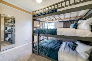 two bunk beds in a room with a mirror at Pooler Praline - 5BR - Sleeps 12 (Close to Savannah & Airport) in Savannah