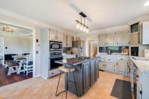 a kitchen with white cabinets and a large island at Pooler Praline - 5BR - Sleeps 12 (Close to Savannah & Airport) in Savannah