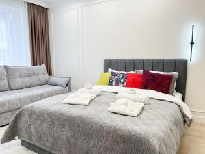 1 dormitorio con 1 cama con 2 toallas en ЖК "4You" one room apartment en Almaty