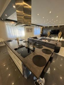 a kitchen with a large island in a living room at Bogyó Family Land Budapest in Budapest