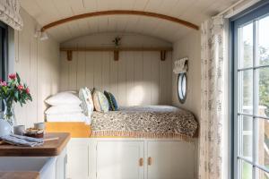 a bed in a small room with a window at Dusky Cottage in Hope Cove