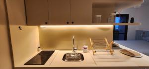 a kitchen with a sink and a stove and a counter top at Flat confortável próximo a praia! in Rio de Janeiro