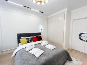 a bedroom with a large bed with towels on it at ЖК "4You" one room apartment in Almaty