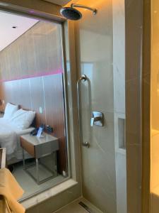 uma casa de banho com um chuveiro, uma cama e um espelho. em Hotel Nacional RJ - Vista Mar no Rio de Janeiro