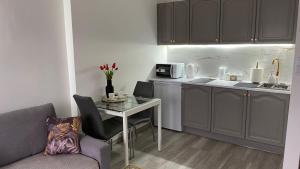 a small kitchen with a table and a microwave at Apartament Gdańska 230 in Bydgoszcz