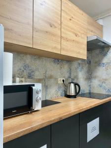 a kitchen with a counter top with a microwave at HALBY rooms Rondo ONZ in Warsaw