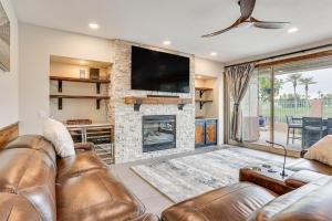 a living room with a couch and a fireplace at Goodyear Home with Private Patio and Golf Course View in Goodyear