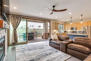 a kitchen and living room with a couch and a table at Goodyear Home with Private Patio and Golf Course View in Goodyear