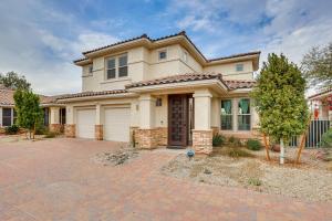 a house with a brick driveway in front of it at Goodyear Home with Private Patio and Golf Course View in Goodyear
