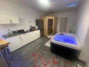 a kitchen with a large tub in the middle of a room at Lavitas SPA in Moravče