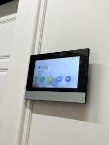 a tablet is hanging on a wall at ЖК "4You" one room apartment in Almaty