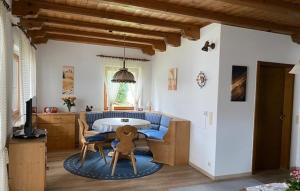 a living room with a blue couch and a table at Ferienwohnung Deininger inkl. Chiemgaukarte in Ruhpolding