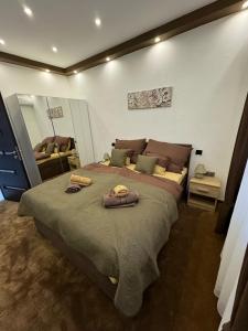 a bedroom with a large bed with two pillows on it at Bogyó Family Land Budapest in Budapest