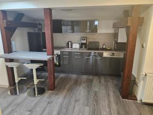 a kitchen with a table and chairs in a room at Suite Dari in Bernburg