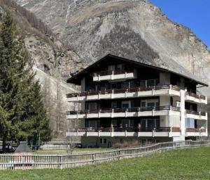 a large building in front of a mountain at Studio Haus Castello in Randa