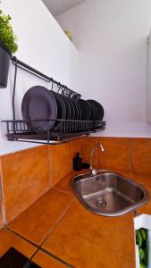 a kitchen counter with a sink and a plate on a shelf at El poniente in Caleta de Sebo