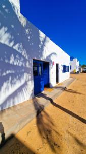 a shadow of a building with a blue door at El poniente in Caleta de Sebo