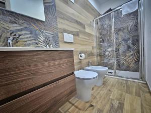 a bathroom with a toilet and a shower at B&B Be happy in Taranto