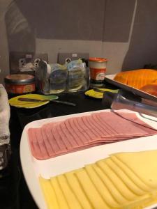 a table with a plate of meat and other ingredients at I-Hotel Piracicaba in Piracicaba