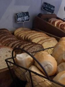 a bunch of loaves of bread on display in a bakery at I-Hotel Piracicaba in Piracicaba