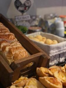 a bunch of breads and pastries on a table at I-Hotel Piracicaba in Piracicaba