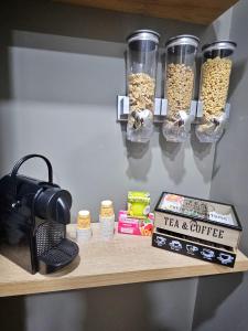 a shelf with jars of cereal and a tea and coffee at B&B Be happy in Taranto
