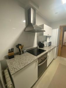 a kitchen with a sink and a counter top at Playa de Pereiró in Bueu