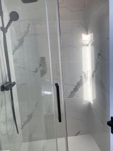 eine Dusche mit Glastür im Bad in der Unterkunft Beau 2 pièces - Mairie de Clichy in Clichy
