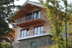 a building with a balcony on the side of it at Chalet Zauberberg in Zwiesel