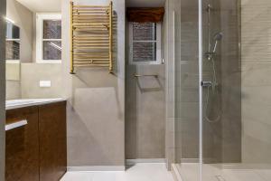 a bathroom with a shower with a glass door at Chełmońskiego 8-01 by Farkas Apartments in Poznań