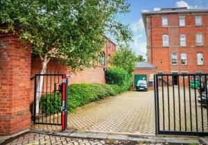 a gate in front of a brick building at County House City Centre with parking Sleeps 4 in York