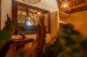 a bathroom with a mirror and a sink and a window at Eco Xata in Santa Veronica