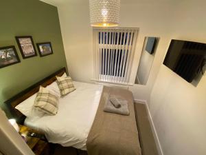 a bedroom with a bed with a bench in it at Wellbank View - Brand New in Washington