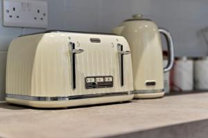 two toasters sitting on top of a kitchen counter at Becky's House: Near Motor Point Arena with Free Parking in Nottingham