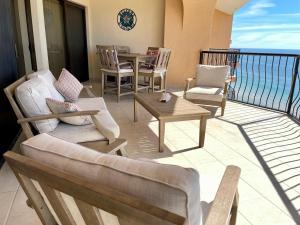 a balcony with chairs and a table and the ocean at Sonoran Sea Resort Oceanfront PENTHOUSE in Puerto Peñasco