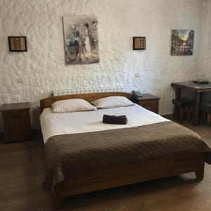 a bedroom with a large bed with a bag on it at Complex Khutor in Velyka Omelyana