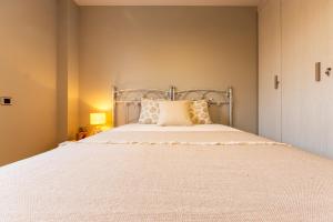 a bedroom with a bed with a white bedspread at SUNSET HOLIDAY RIUMAR in Riumar +21 photos