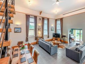 a living room with two couches and a table at Firs Retreat in Balderton