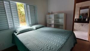 Postel nebo postele na pokoji v ubytování Sítio Encontro das Águas Brotas